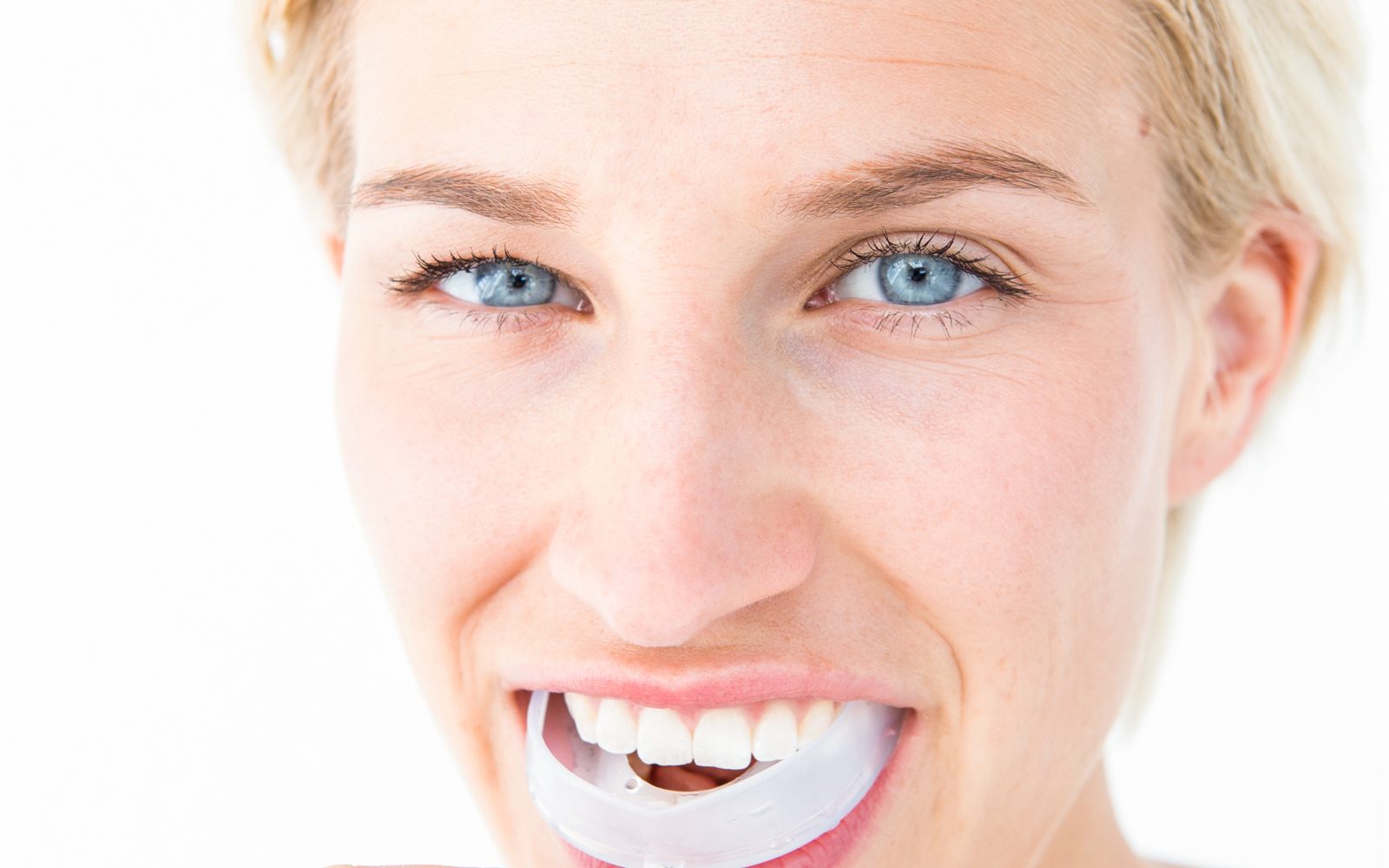Patient fitting a custom mouthguard made by a Fresno, CA dentist