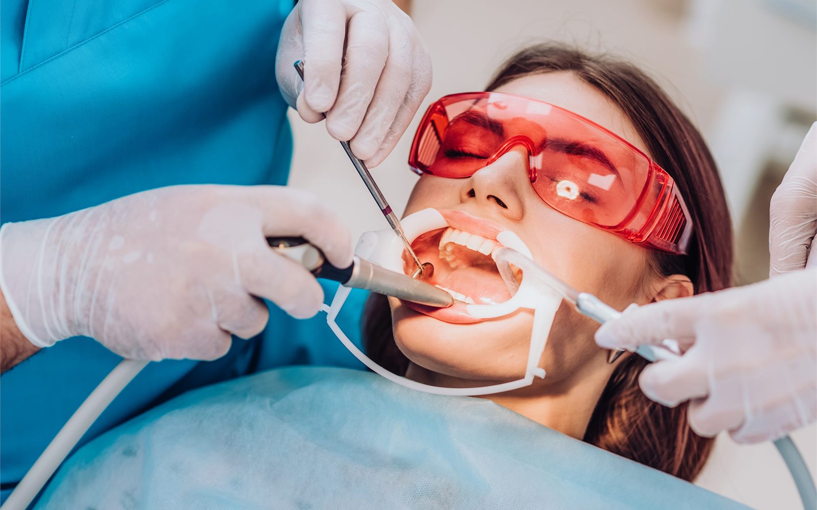 Hygienist performing a professional dental cleaning in Fresno, CA