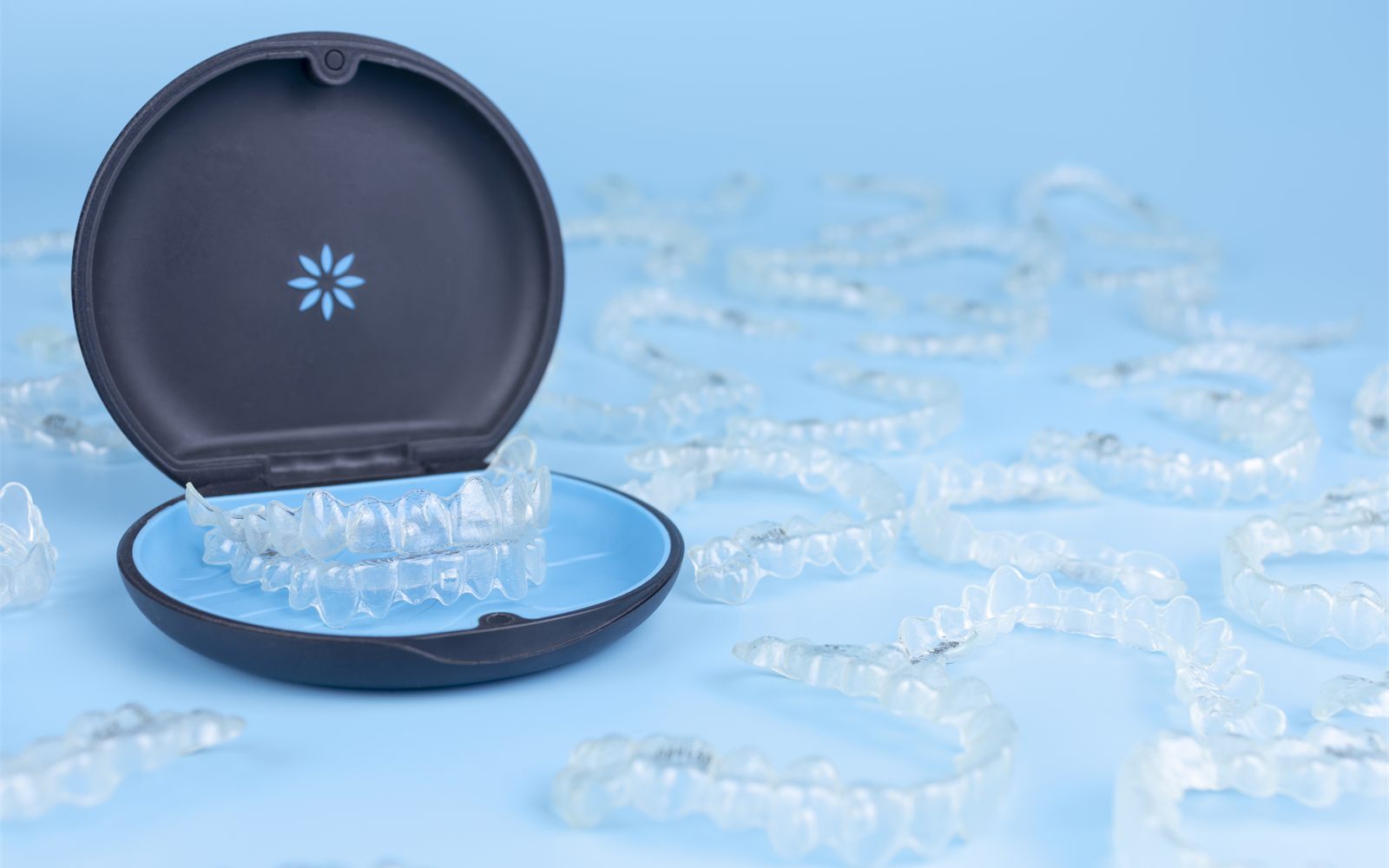Clear removable retainers in their case, fitted by a Fresno, CA dentist
