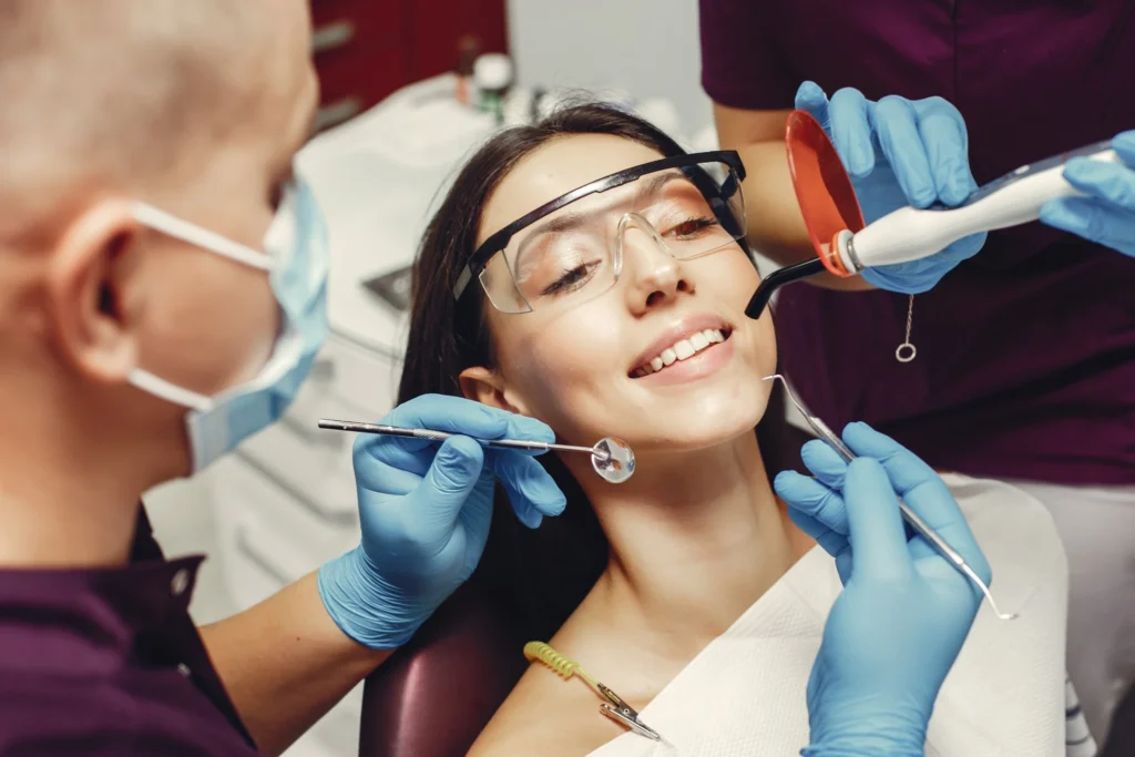 Smiling woman receiving dental treatment under sedation, showcasing anxiety-free care in Fresno