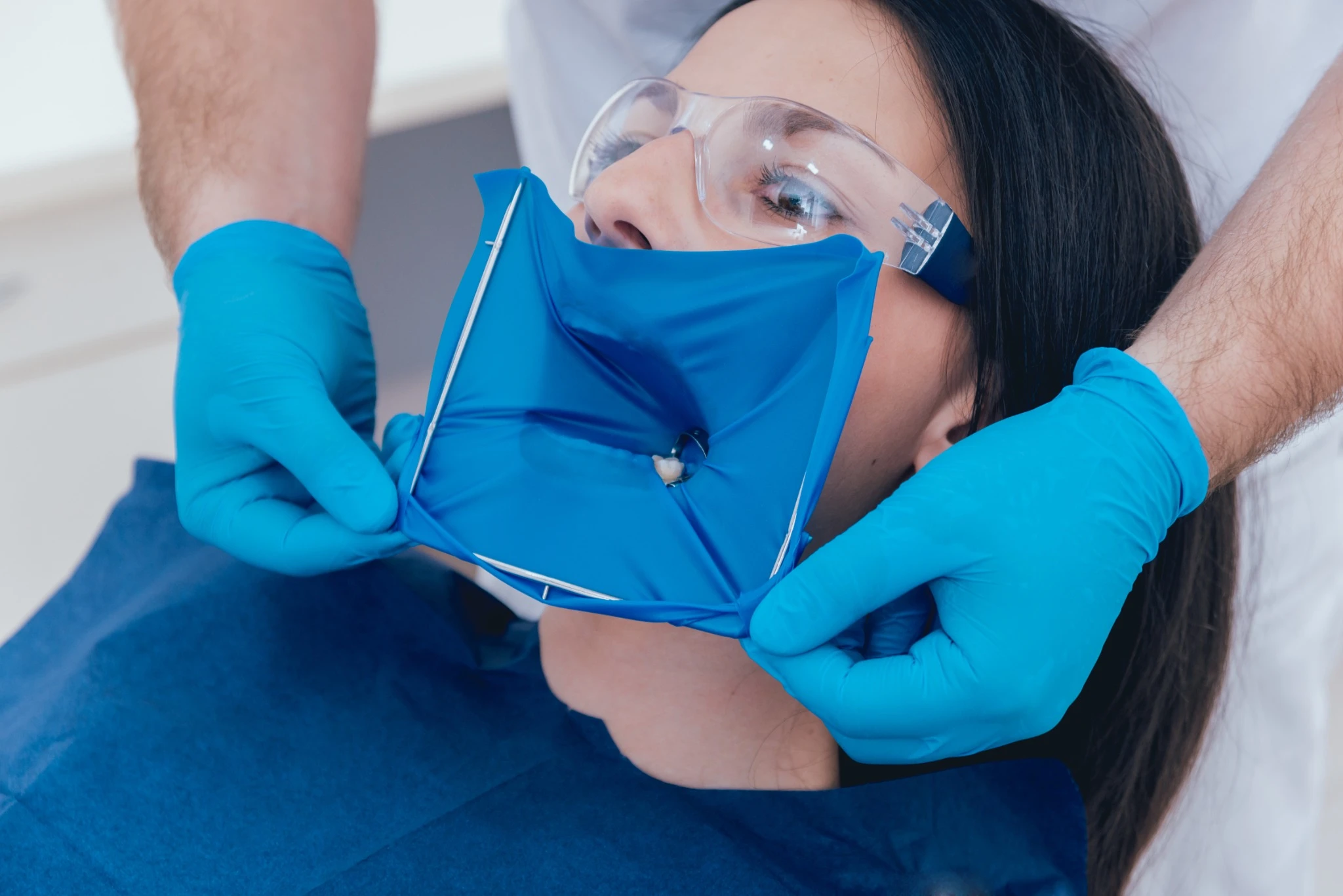 Close-up of dental dam placement during emergency procedure