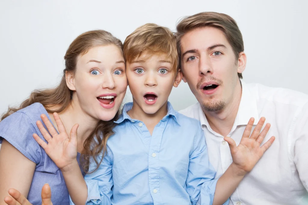 A surprised family of three reacting to dental health information, used for educational blog content in Fresno