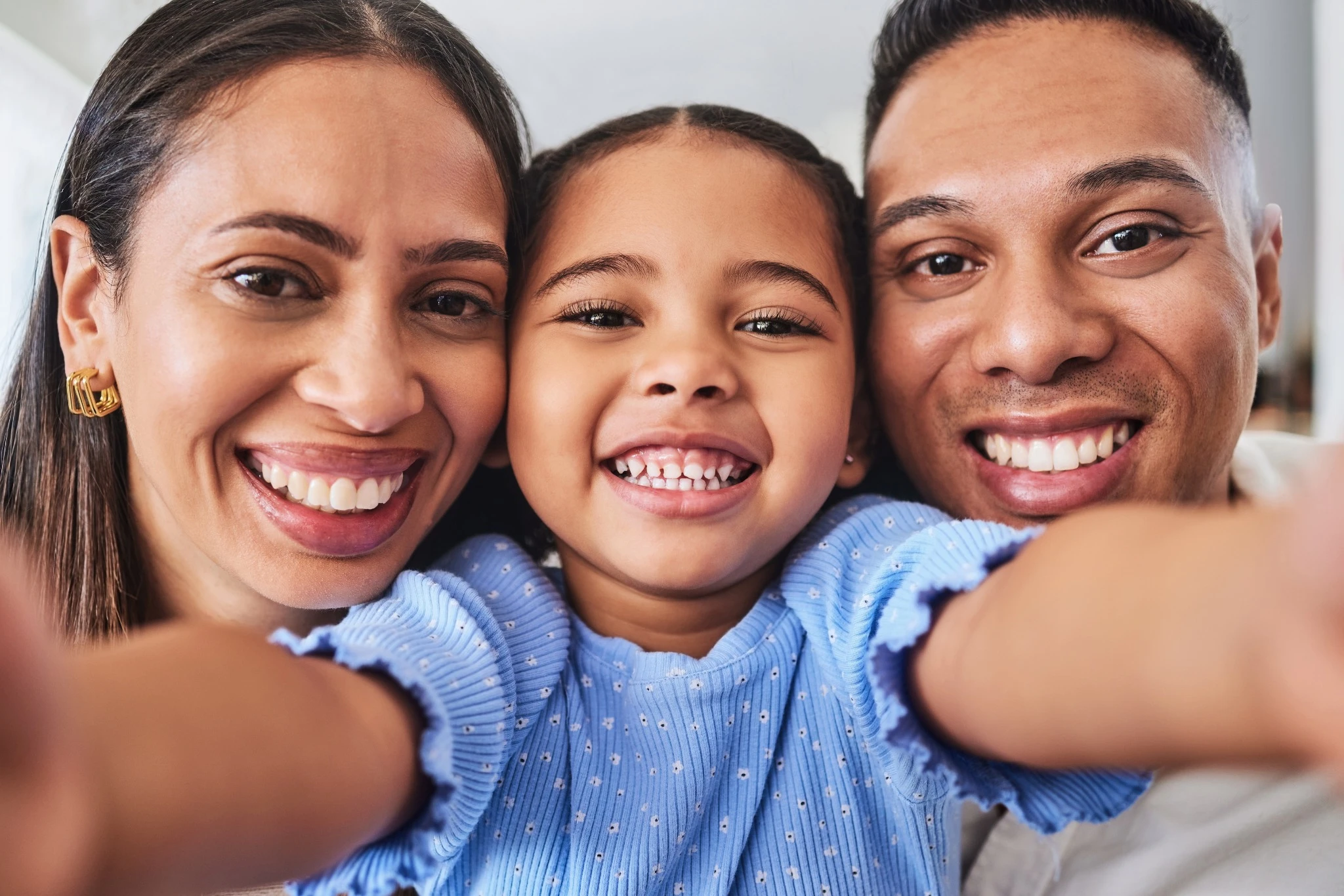 A joyful family taking a selfie, showcasing healthy smiles after pediatric dental care in Fresno